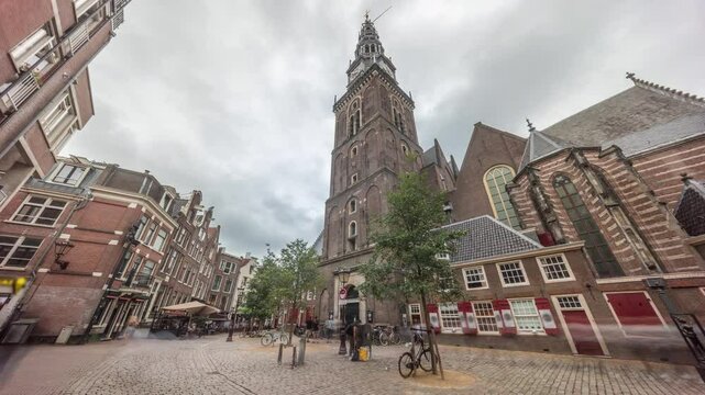 Hyperlapse of Amsterdam's Old Church (Oude Kerk), the city's oldest parish church, surrounded by historical houses in De Wallen district on Oudekerksplein timelapse. Iconic landmark in the Netherlands