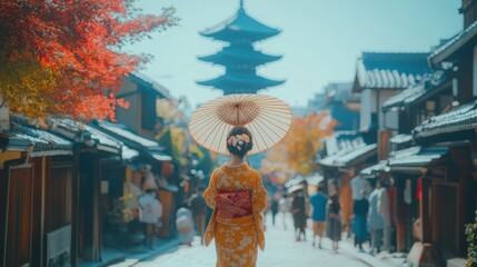 A woman in a traditional Japanese kimono walks down a street in Kyoto, Japan, with a pagoda in the background.