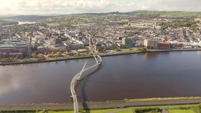 City of Derry aka Londonderry in Northern Ireland aerial view - A Beautiful Cityscape from above by the River Foyle Featuring the Beautiful Pedestrian Peace Bridge