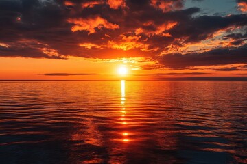 Obraz premium A stunning sunset over the ocean. Use this photo for projects related to travel, nature, or relaxation.