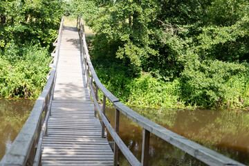 A wooden bridge across a small river.
