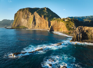 Obraz premium Aerial view of Madeira cliffs coastline landscape on sunrise, Guindaste viewpoint, Madeira island, Portugal