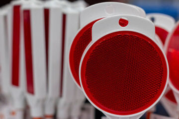 Reflective safety paddles displayed for sale at a roadside shop during the day