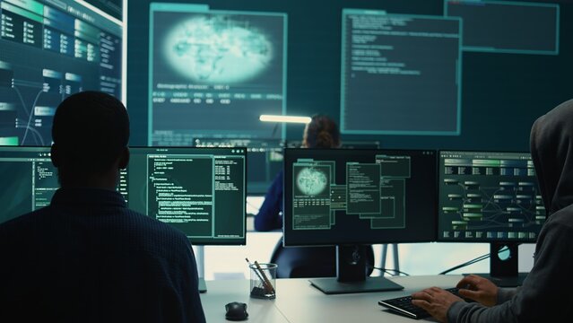 Governmental agency team conducting cyber security monitoring and threat detection tactics. IT experts work on cybercrime prevention, network security and information protection. Camera B.