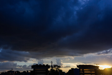 Dramatic sunset sky with dramatic clouds and silhouette of  tower