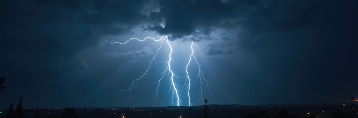 Dramatic capture of a thunderstorm featuring striking lightning bolts illuminating the dark clouds, perfect for showcasing weather phenomena or nature's power.