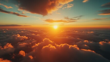 Fototapeta premium Sunrise over a sea of clouds as the warm golden rays illuminate the horizon during a peaceful morning