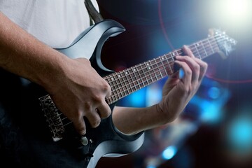 Fototapeta premium Bassist's music man hands playing on guitar
