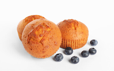 Delicious sweet muffins and blueberries isolated on white