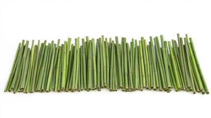 Group of thin green bamboo stalks arranged neatly, isolated on white background