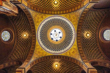 Symmetrical interior ceiling of the Spanish synagogue in prague. Golden details and lamps