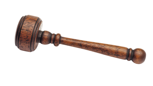 An antique brass wrench isolated on a white background, surrounded by old metal tools and a wooden plug, evoking the essence of classic car engine equipment