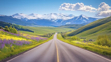 Naklejka premium Explore a narrow road bordered by blooming wildflowers and a sparkling river, surrounded by vibrant greenery and towering mountains under bright spring sunlight. A true nature oasis awaits.