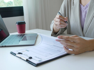 Business woman employer looking for resume to hire job applicant. Holding resume to hire job...