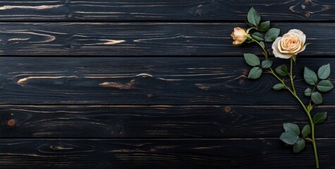 Fototapeta premium A single rose with leaves on a dark wooden surface, creating a serene and elegant composition.