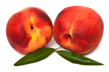 Two fresh peach fruits with leaves isolated on white background