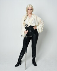 Full length portrait of beautiful female model wearing vintage gothic fantasy blouse, leather...