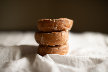three sourdough donuts stacked on a table