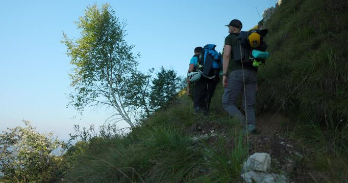 Men Hiking On Grignetta Mountain In Mandello del Lario, Lombardy, Italy. low angle, static shot