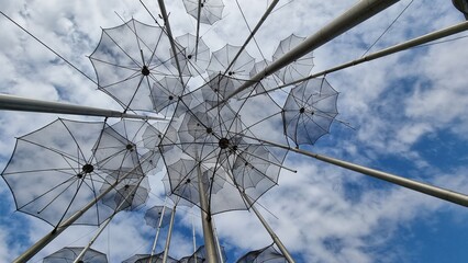 Obraz premium salonica umbrellas metallic street art sea fountain rain cloudy sky greece