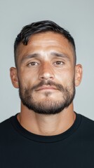 Obraz premium Confident Male Portrait with Short Hair and Beard Against a Neutral Background