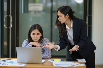 Asian businesswoman employee stressed out at the office, and her boss was angry, blaming her.