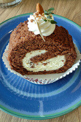 Tiramisu roll cake on a blue plate
