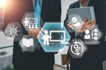 Business professionals collaborating on capacity building with digital training icons and...
