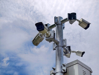 Multiple security cameras installed to ensure safety, set against a beautiful sky background