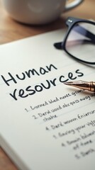 Human resources notes with glasses and fountain pen on desk