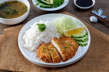 Tonkatsu Pork Rice cutlet and shredded cabbage on a white plate
