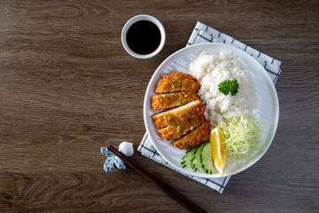 Tonkatsu Pork Rice cutlet and shredded cabbage on a white plate