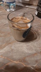 Delicious cappuccino in a glass cup