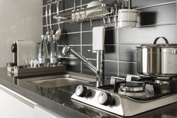 Pot with lid on cooktop in kitchen