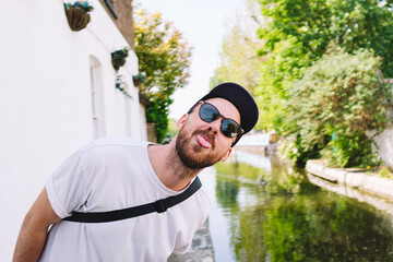 Playful Man Making a Face by the Canal