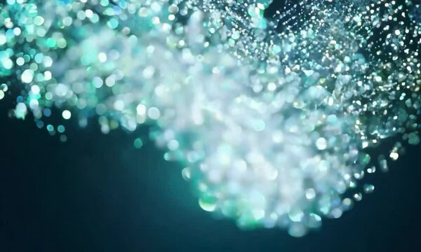 Tilt shot with shimmering patterns: The camera starts with a close-up of micro-particles illuminated by shimmering light. The camera tilts to reveal the particles&rsquo; interactions with the light, creatin