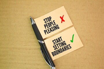 pens and paper  with the words STOP PEOPLE PLEASING START SETTING BOUNDARIES. maintaining healthy...