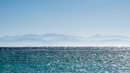 Mountains in the haze near the sea. Dahab town in Egypt.