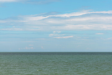 Serene seascape with calm ocean waters meeting a clear blue sky. The horizon line blends smoothly, creating a peaceful and tranquil natural scene. Perfect for backgrounds, travel, and nature.