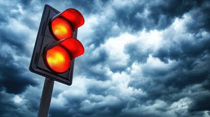 Red Traffic Light Against Dramatic Sky