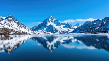 A stunning mountain landscape reflected in a serene lake under a clear blue sky, showcasing snow-capped peaks and tranquil waters.