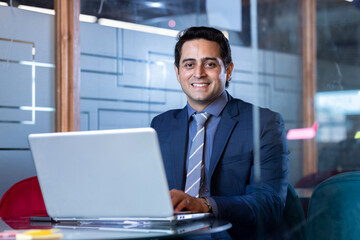 Fototapeta premium Successful businessman in modern office working on laptop
