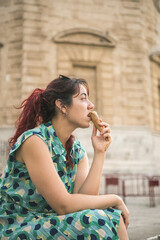 Fototapeta premium middle aged redhead woman eating ice cream