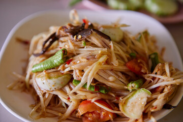 Spicy green papaya salad or Som Tum Thai food served on plate