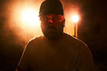 Dark room, glowing glasses figure © Cavan