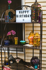 Moroccan outdoor birthday party setting with happy birthday sign