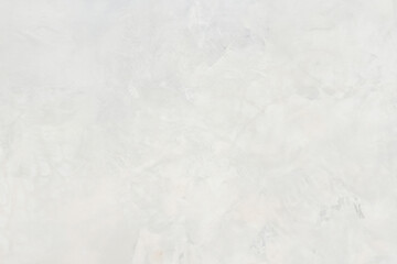 Close-up of a light, textured plaster wall with subtle patterns and an abstract design, ideal for backgrounds.