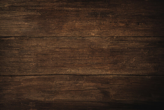 Close-up of a dark rustic wooden plank surface with natural textures and wood grain patterns. - Powered by Adobe