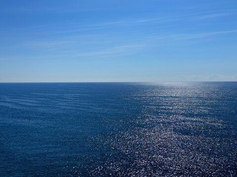 Blue ocean shiny water and clear blue sky.