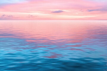 Fototapeta premium Calm sunset over a serene lake with soft pink and orange hues reflecting on the water's surface.